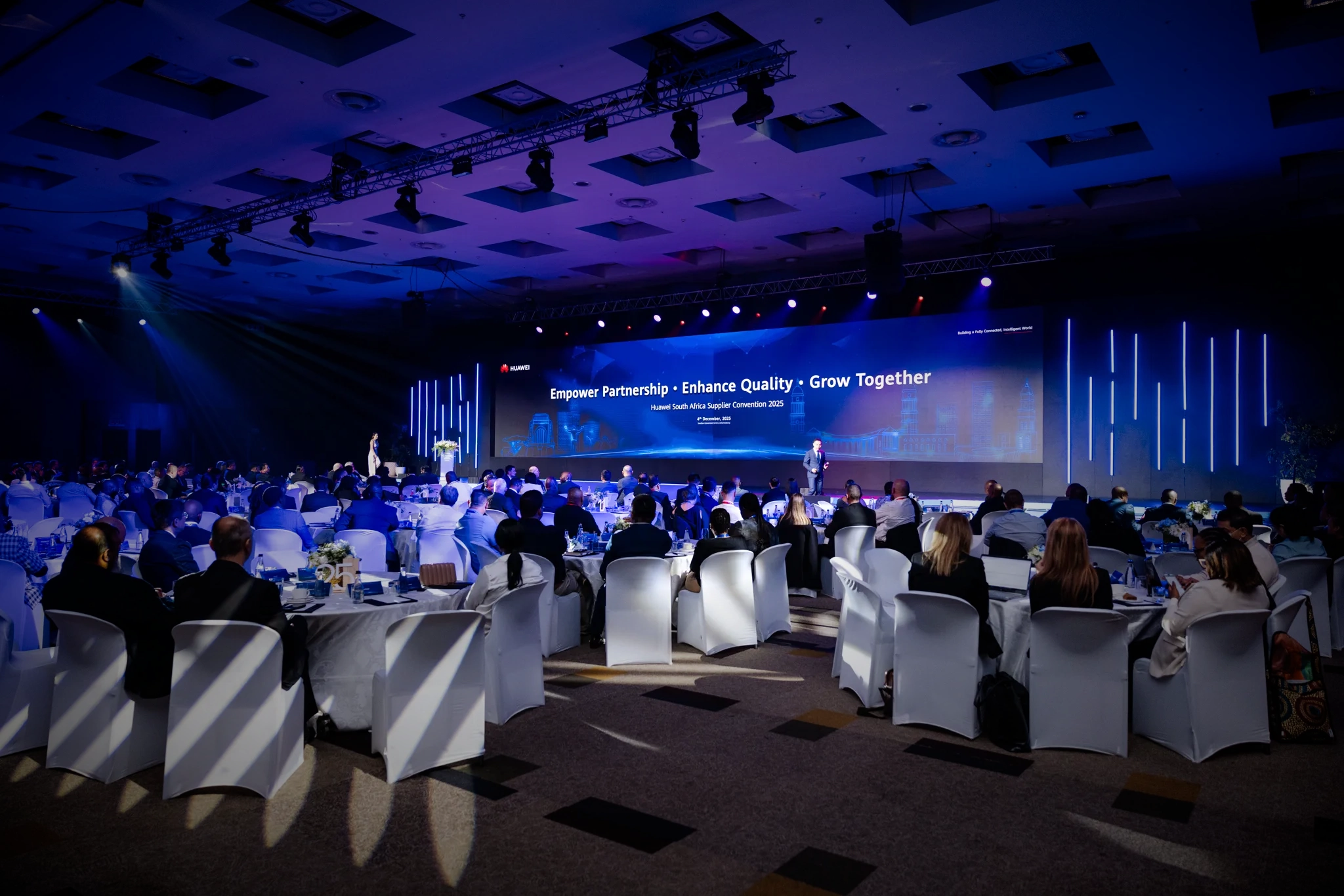 Guests at the Huawei South Africa Supplier Convention facing a large LED stage